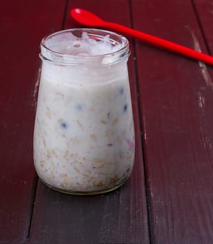 Healthy breakfast - yogurt with blueberries and muesli served in glass jar, Lazy oatmeal