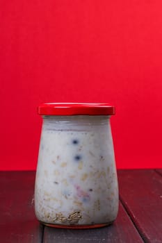 Healthy breakfast - yogurt with blueberries and muesli served in glass jar, Lazy oatmeal