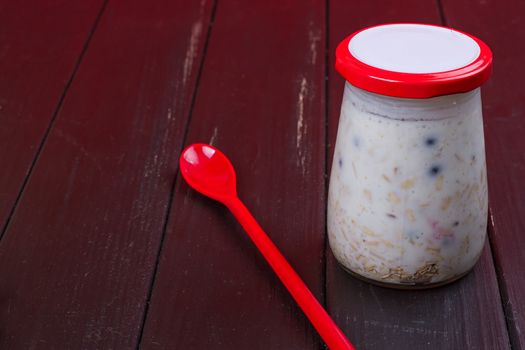 Healthy breakfast - yogurt with blueberries and muesli served in glass jar, Lazy oatmeal