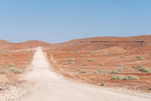 The orange-red, rocky Namib desert landscape at Dopsteekhoogte Pass on the C39-road to Torra Bay, in the Kunene Region of Namibia