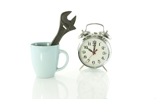 time for a coffee break during work with blue coffee cup and metal tool and clock on ten o clock