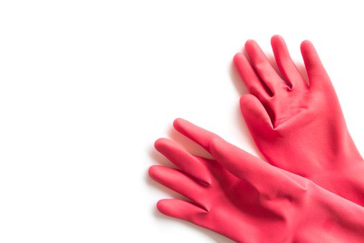 Closeup Red rubber gloves for cleaning on white background, workhouse concept