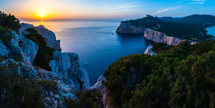 Landscape of the gulf of capo caccia from the Cave of broken vessels at sunset