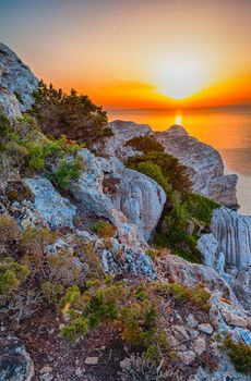 Landscape of the gulf of capo caccia from the Cave of broken vessels at sunset