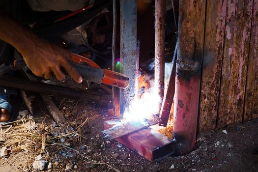 Arc welding and welding fumes, Worker welding on steel in the job site.
