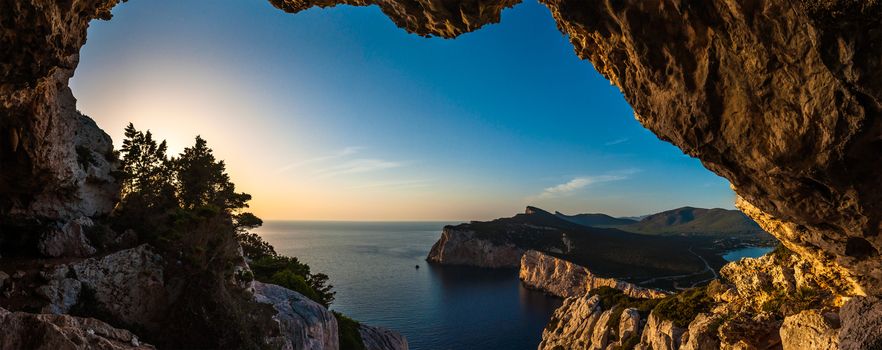 Landscape of the gulf of capo caccia from the Cave of broken vessels at sunset