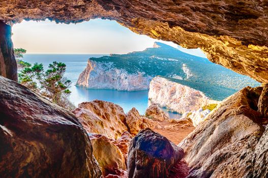 Landscape of the gulf of capo caccia from the Cave of broken vessels at sunset