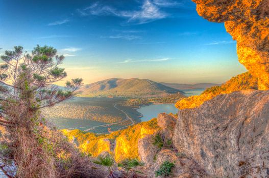 Landscape of the gulf of capo caccia from the Cave of broken vessels at sunset