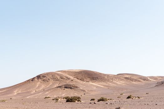 A rock and sand Namib desert landscape near Springbokwasser in the Kunene Region of Namibia