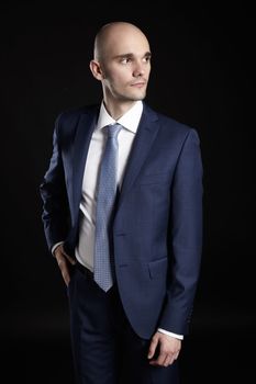 Portrait of elegant man looking left. Man on black background.