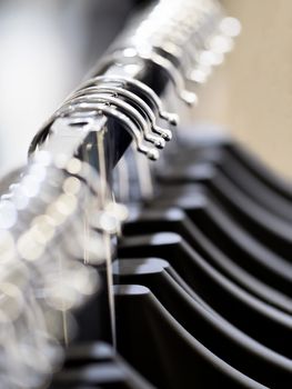 close up of row  of clothes hanger defocused