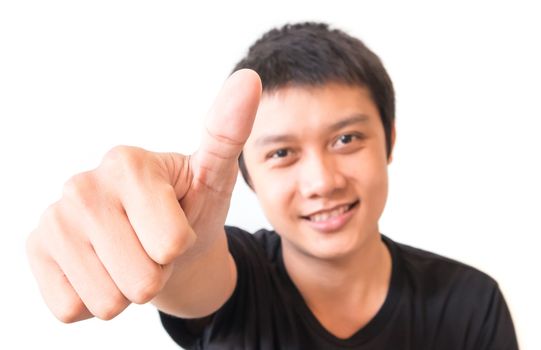 Closeup asian young man showing thumbs up with white background, excellent symbol