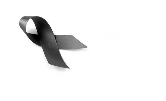 Black ribbon symbol for mourning on white background