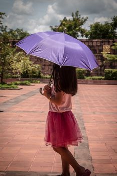 Cute girl standing in fashion photo in the sun