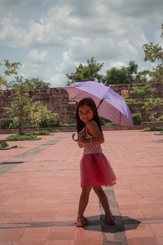 Cute girl standing in fashion photo in the sun