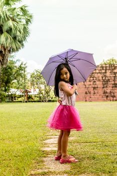 Cute girl standing in fashion photo in the sun