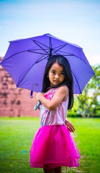 Cute girl standing in fashion photo in the sun