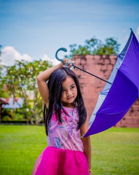 Cute girl standing in fashion photo in the sun