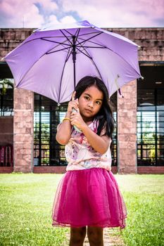 Cute girl standing in fashion photo in the sun