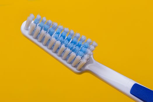 Toothbrushes on the yellow background. Top view