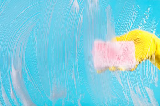 Cleaning conept, hand cleaning glass window pane with detergent and wipe or sponge