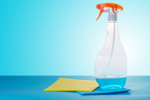 cleaning agent and sponges on a blue background