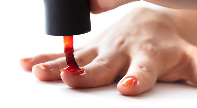 hand care, nail painting with red lacquer