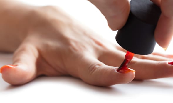 hand care, nail painting with red lacquer