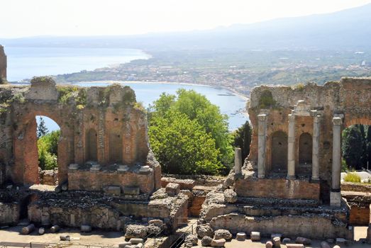 the Ancient Theatre of Taormina with Etna Mountain and mediterranean sea in background in Sicily, Italy