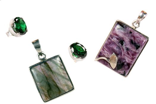 A set of pendants and rings made of silver and semi-precious stones of different colors.