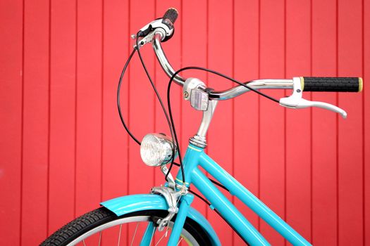 retro bicycle in front of the red wall background