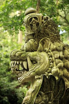 Balinese stone statue before a temple