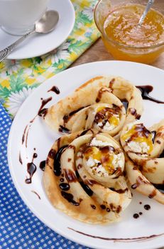 Pancake folded in the form of a snail cottage cheese with chocolate