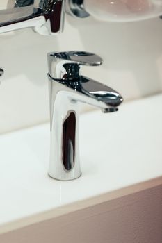 Modern faucet for water on the sink or on the wall, note shallow depth of field