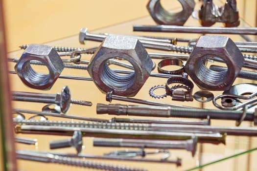 screws, nuts, clamps ...on the glass, note shallow depth of field