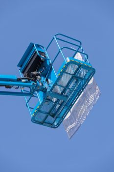 Crane with basket on the blue background, note shallow depth of field