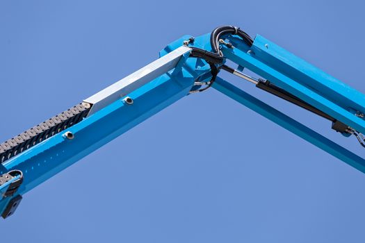 Details crane in construction on the blue background, note shallow depth of field