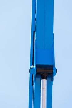 Details crane in construction on the blue background, note shallow depth of field