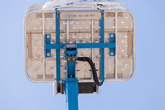 Crane with basket on the blue background, note shallow depth of field