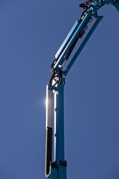 Details crane in construction on the blue background, note shallow depth of field