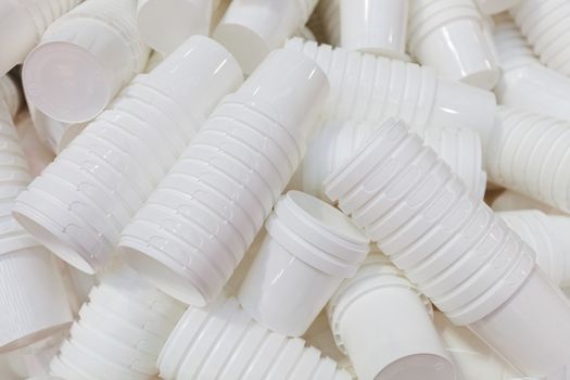 products from machinery for the production of plastic cups, note shallow depth of field