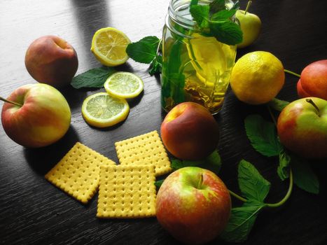 Natural fresh tea in a cup on wooden table with lemon and apples. Concept for eco lifestyle. Healthy food theme