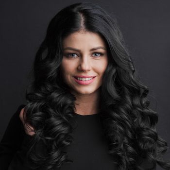 Portrait of gorgeous brunette with curly long hair