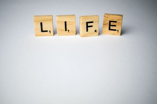 Scrabble tiles with word life written in a white background