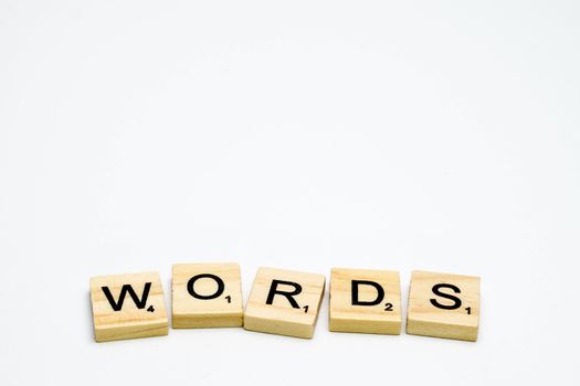 Scrabble tiles with word words written in a white background