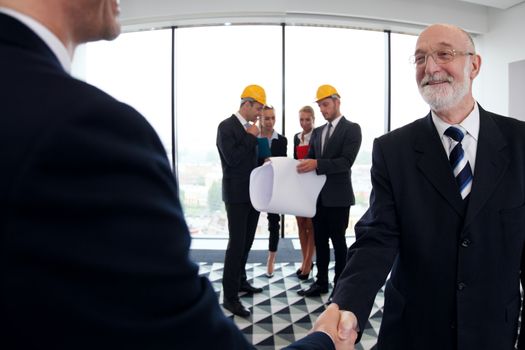 Business meeting of architects and investors shaking hands in office