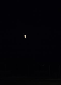 Partial eclipse of the moon in an otherwise dark sky