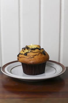 A coffee and chocolate muffin with cream filling