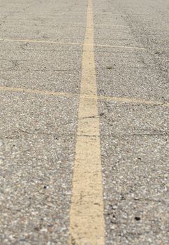 Yellow lines marking off parking spaces in an asphalt lot