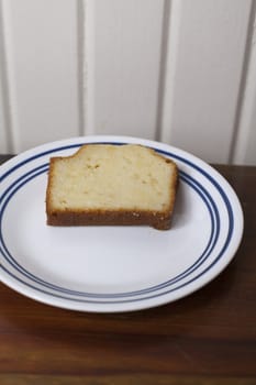 A single slice of pound cake on a small plate